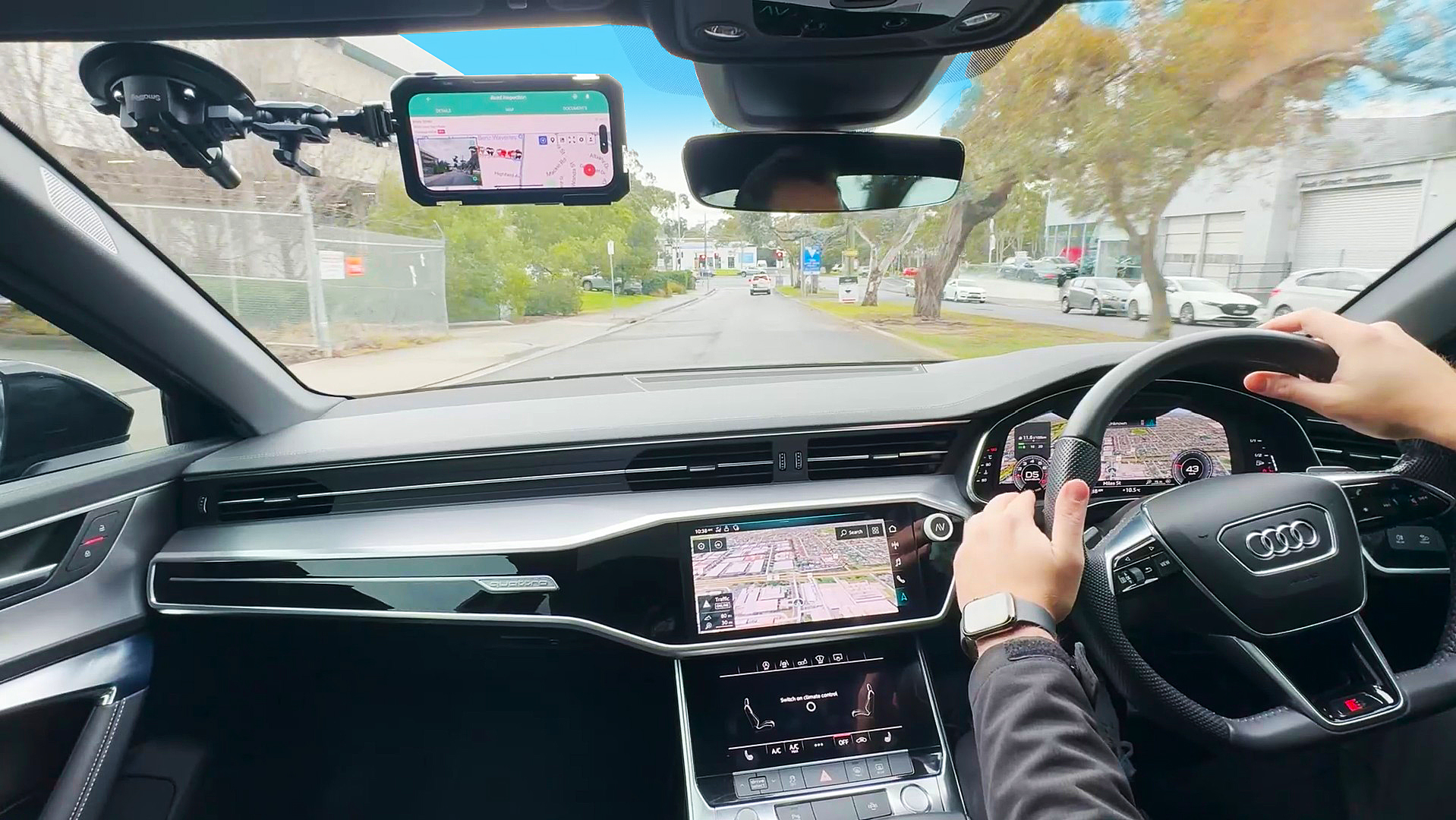 In-vehicle AutoPilot capture setup recording road conditions with mounted camera and navigation screens during a live drive.