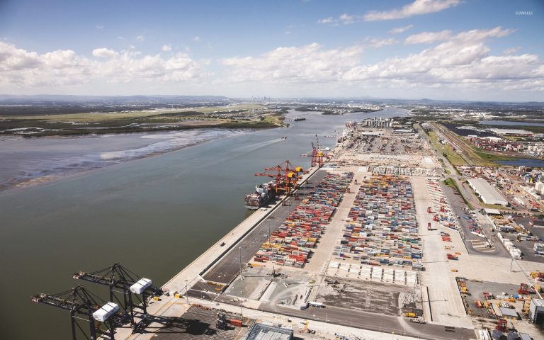 Aerial view of the Port of Brisbane showing container terminals, cranes, and road infrastructure managed using Asset Vision.